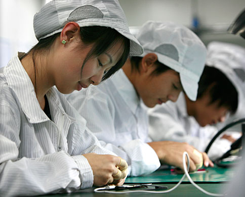 Chinese workers assembling Apple products
