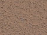 A close up of the shinny object in the Mars sand